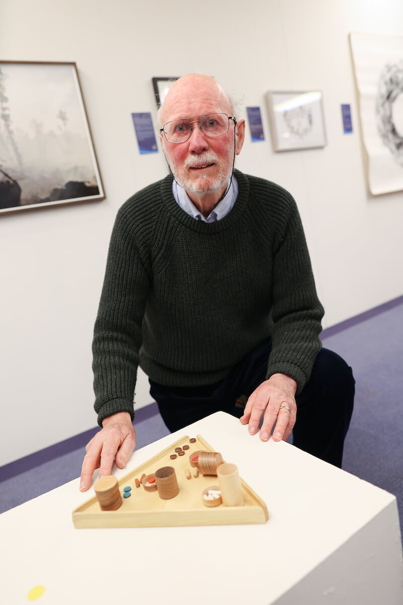Hugh Cummins showing his delicate wood based artwork